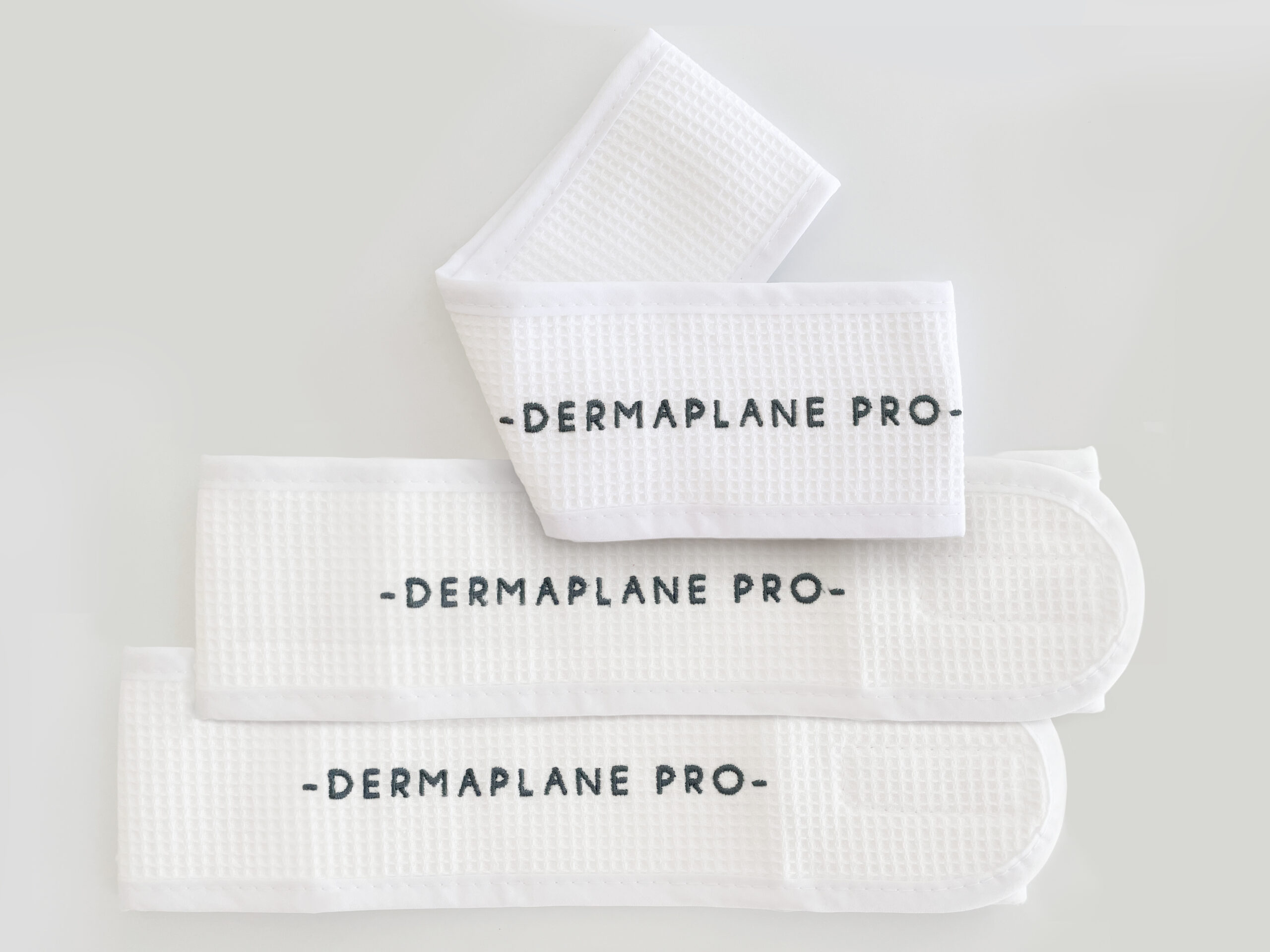 Three pack of DermaplanePro's white, waffle-knit head wraps.