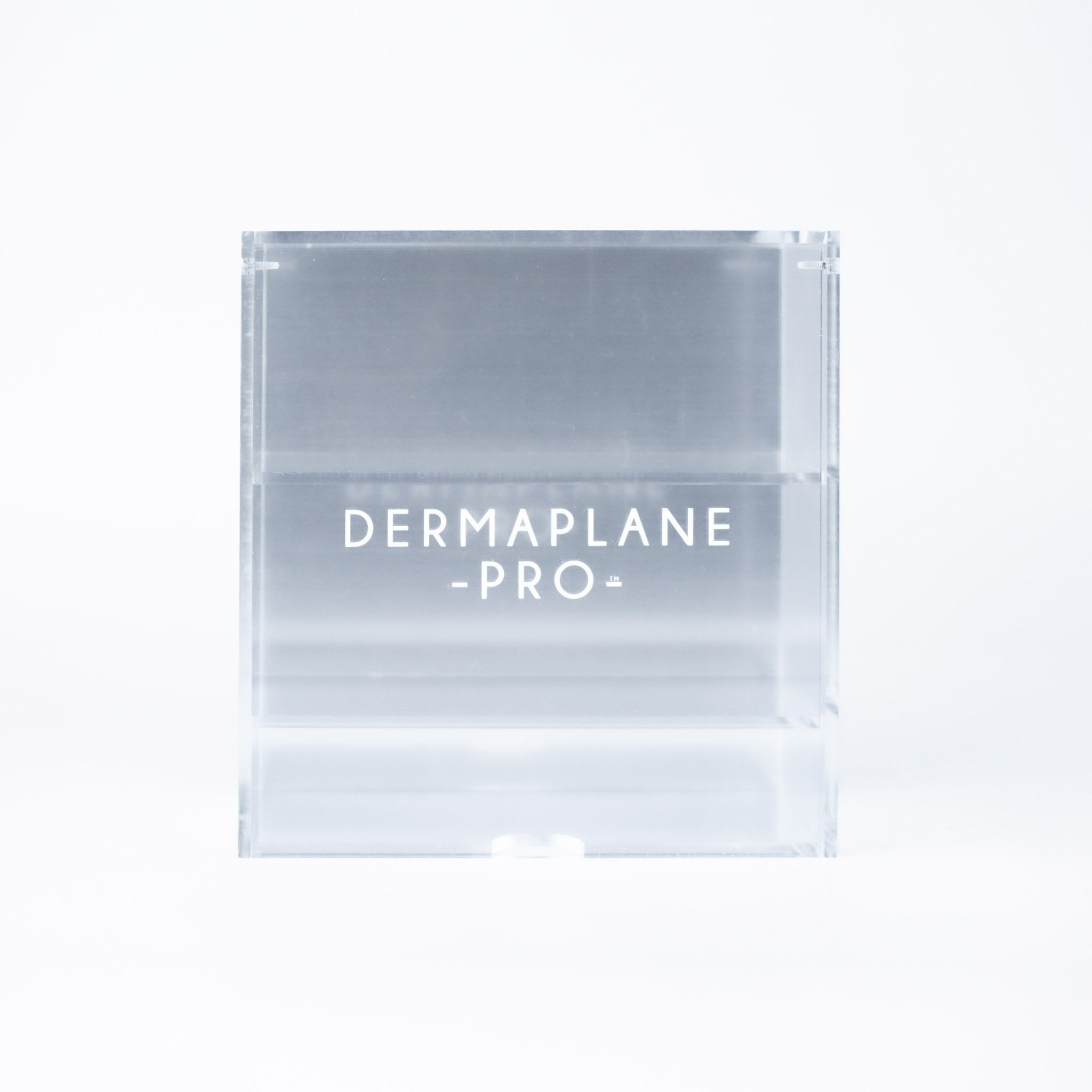 DermaplanePro clear acrylic blade box with silver bottom and white logo.