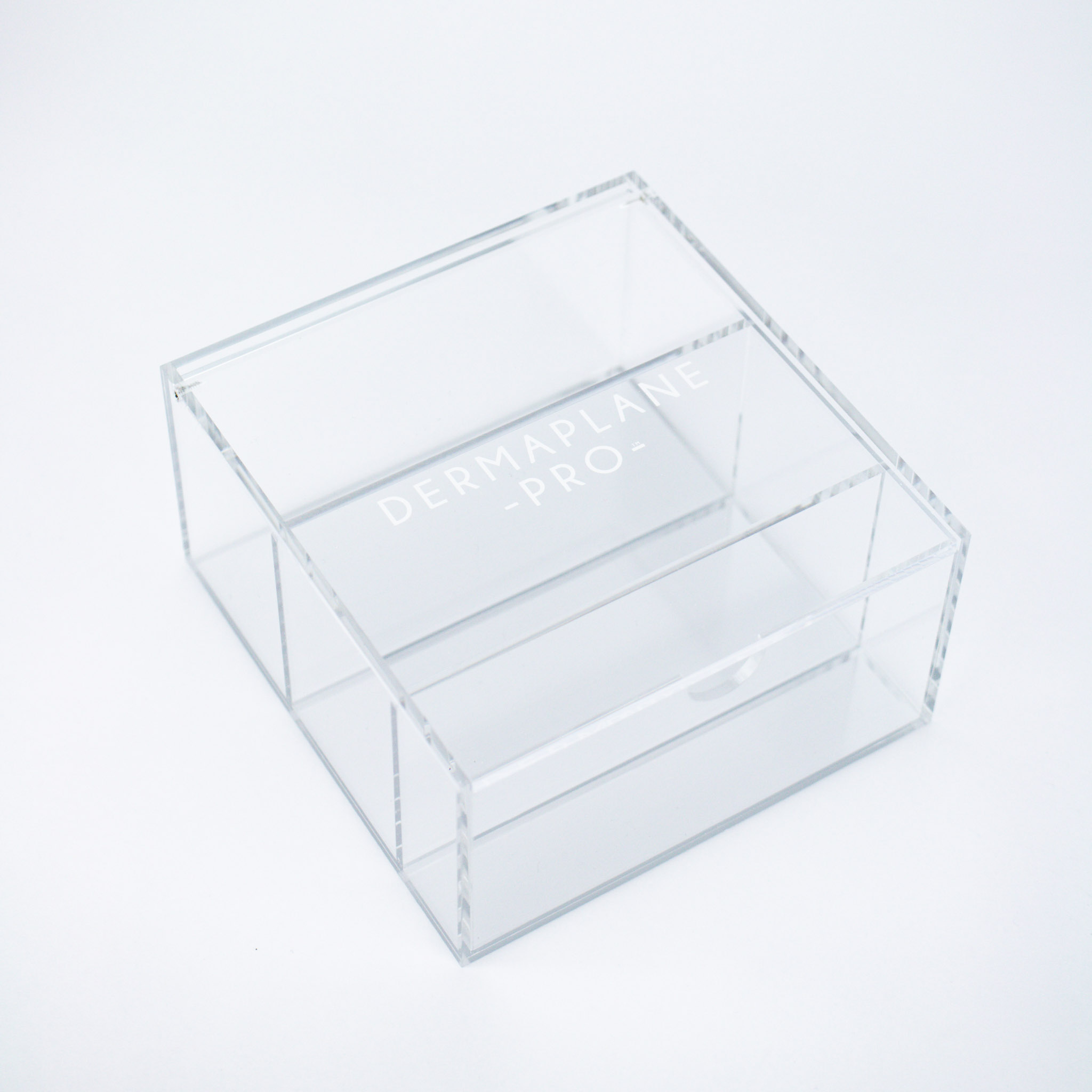 DermaplanePro clear acrylic blade box with silver bottom.